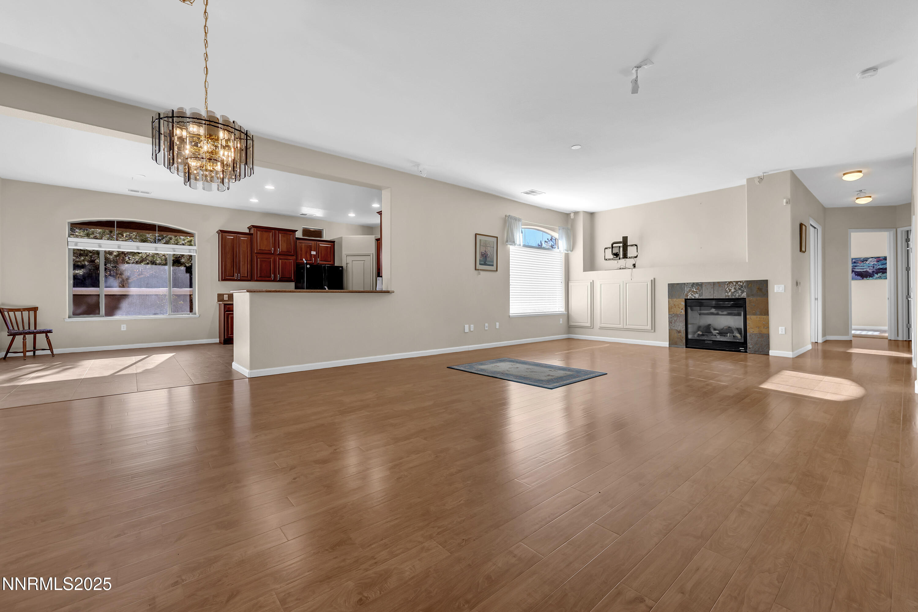 9900 Wilbur May Parkway, Unit 1802 Reno, NV 89521 - Photo 2 of 47 a view of a livingroom with furniture a fireplace and wooden floor