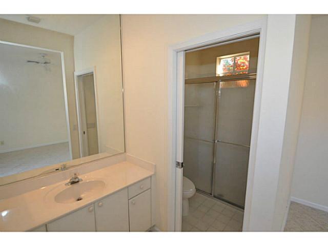 6293 Northwest 23rd Road Boca Raton, FL 33434 - Photo 17 of 25 a bathroom with a sink a mirror and shower