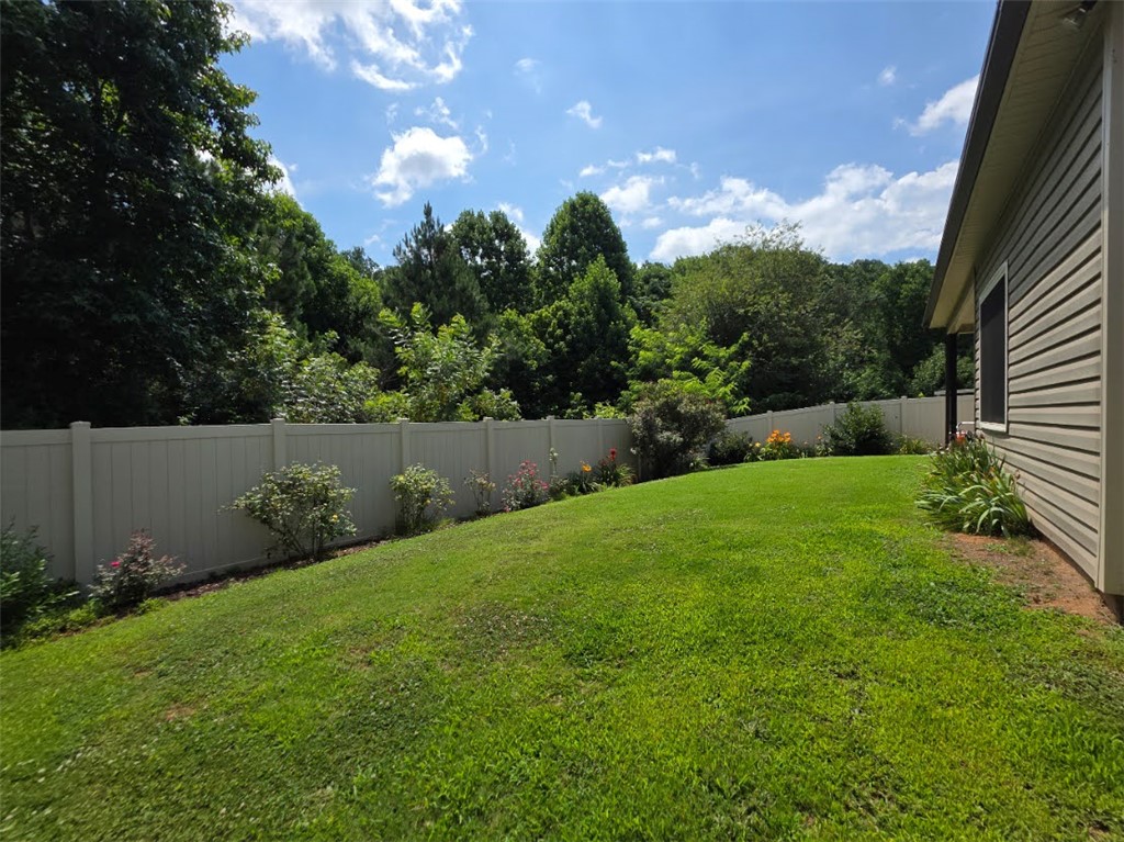 3 Cringle Lane Anderson, SC 29625 - Photo 17 of 26 A verdant backyard with a privacy fence, offering serene outdoor enjoyment.