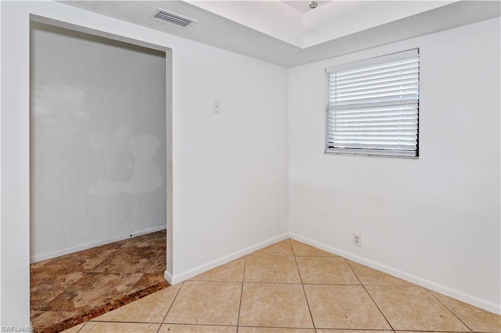 1733 Courtyard Way, Unit 204 Naples, FL 34112 - Photo 11 of 15 Spare room with light tile patterned floors and baseboards