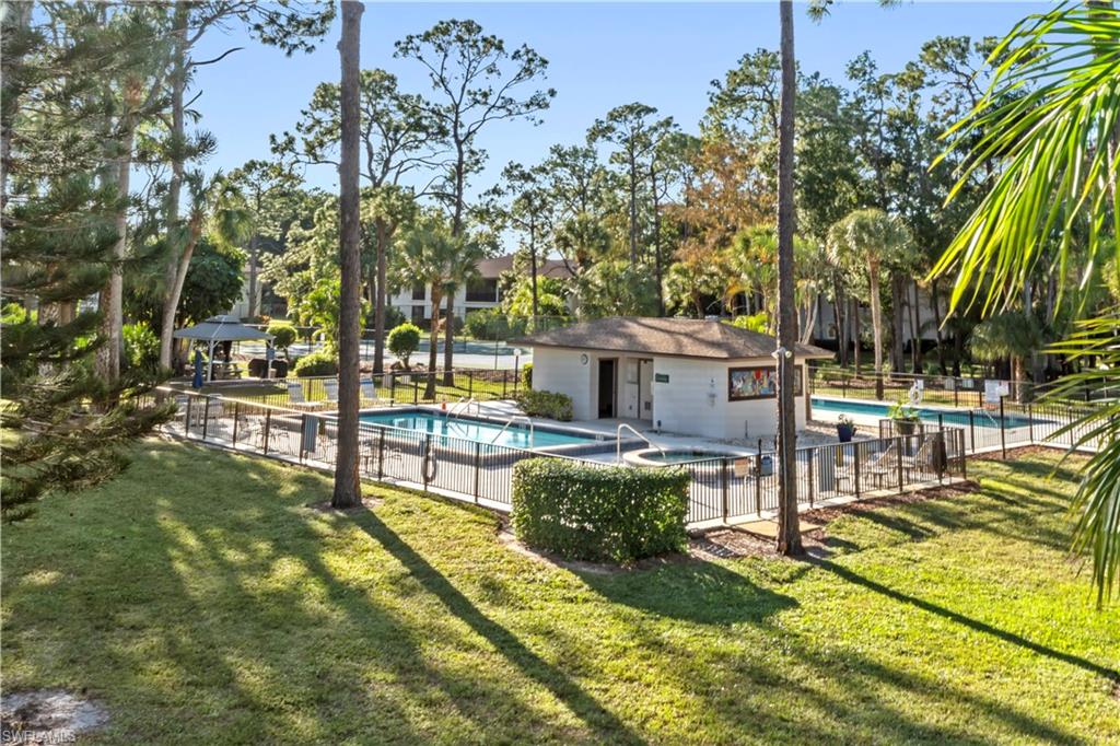 1733 Courtyard Way, Unit 204 Naples, FL 34112 - Photo 13 of 15 Community pool with a patio, a gazebo, a community hot tub, and view of scattered trees