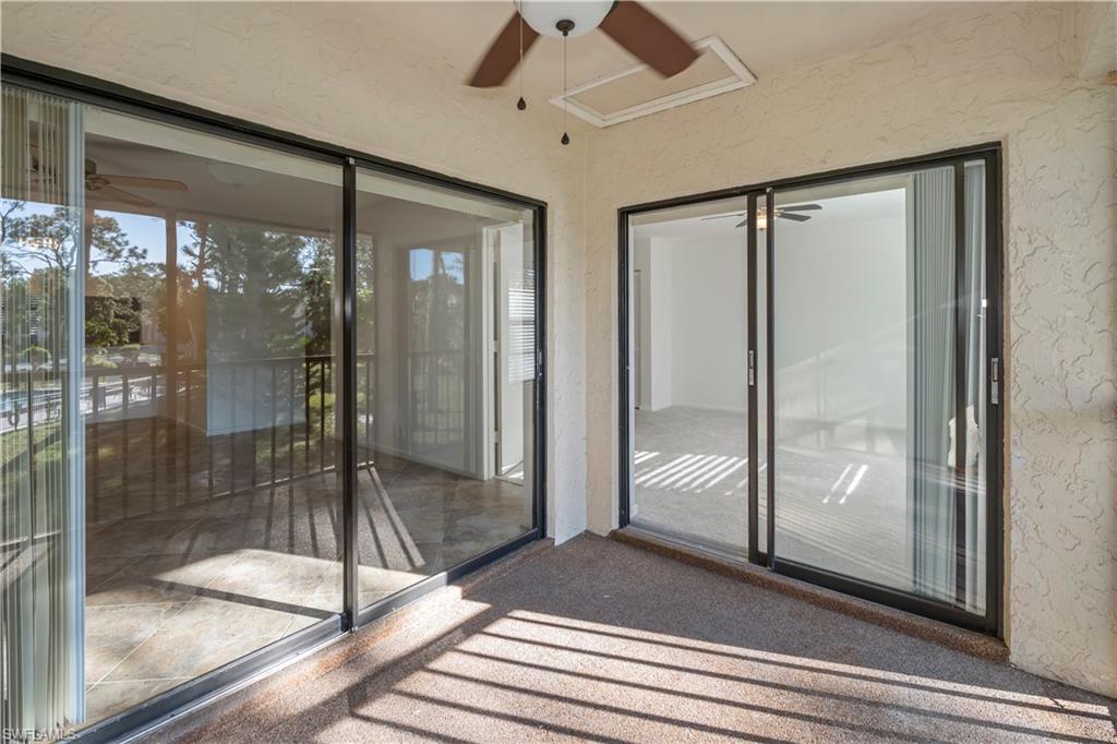 1733 Courtyard Way, Unit 204 Naples, FL 34112 - Photo 14 of 15 Unfurnished sunroom featuring a textured wall