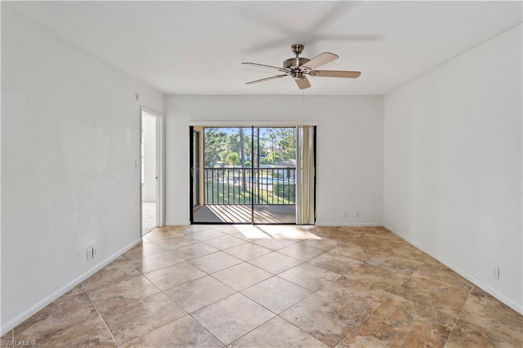 1733 Courtyard Way, Unit 204 Naples, FL 34112 - Photo 4 of 15 Empty room with a ceiling fan and light tile patterned floors