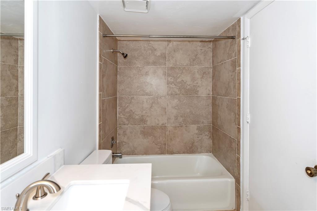 1733 Courtyard Way, Unit 204 Naples, FL 34112 - Photo 7 of 15 Bathroom with shower / bath combination and vanity