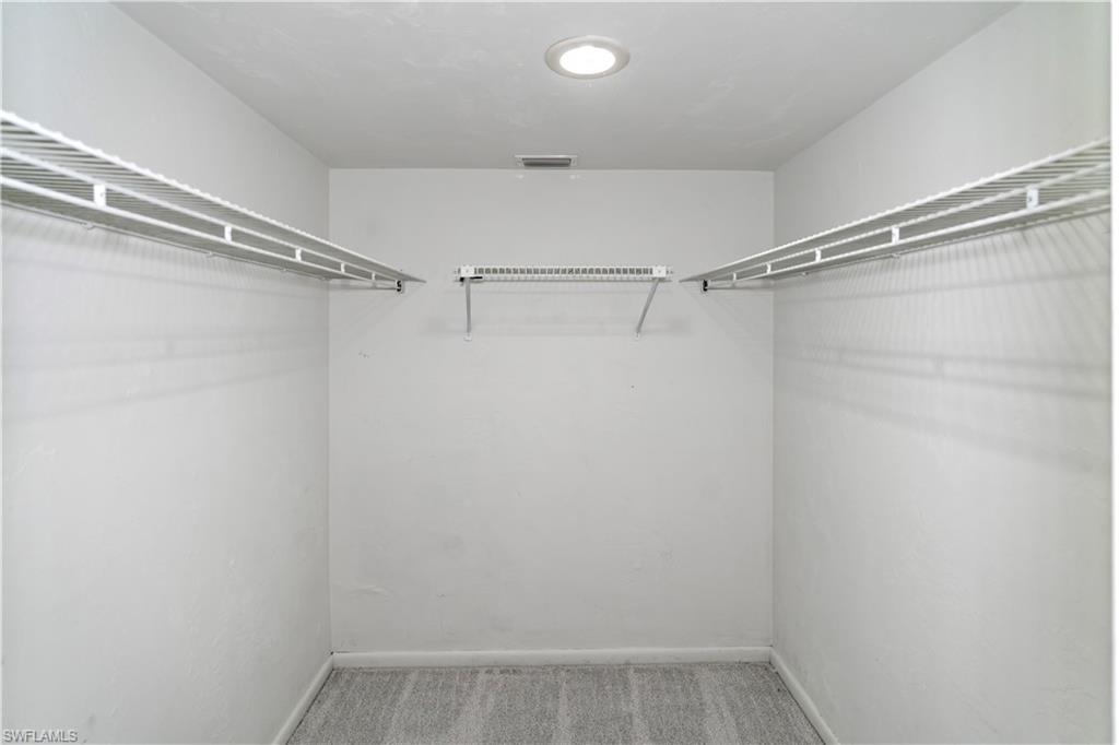 1733 Courtyard Way, Unit 204 Naples, FL 34112 - Photo 10 of 15 Spacious closet featuring carpet