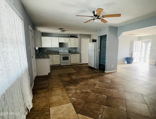 a view of a kitchen with a sink and cabinets
