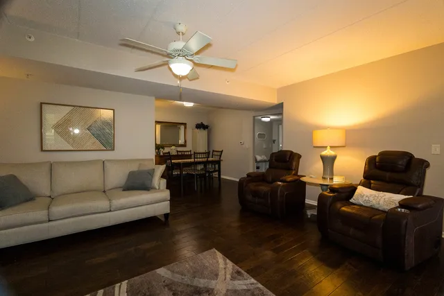 a living room with furniture and a large mirror