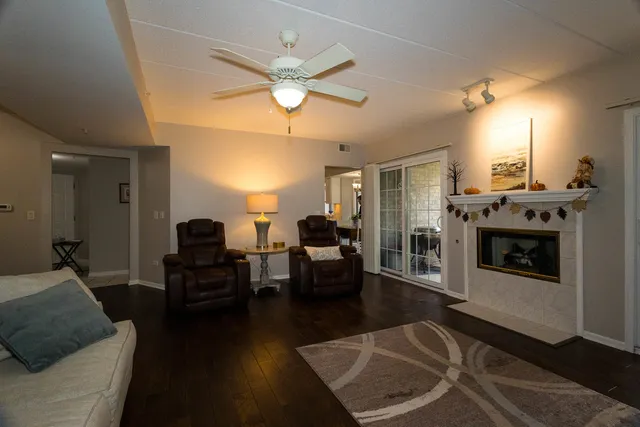a living room with furniture a fireplace and a chandelier