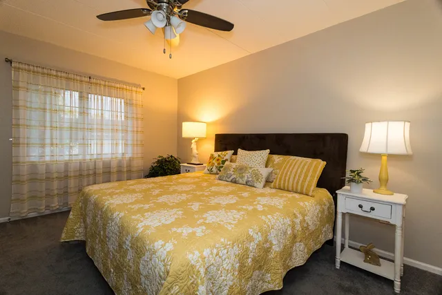 a bed sitting in a bedroom next to a window