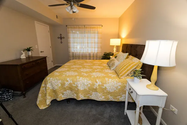 a bed sitting in a bedroom next to a window