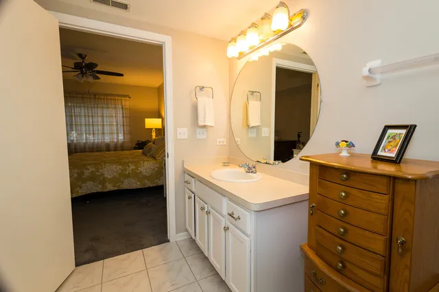 a bathroom with a double vanity sink a mirror and shower