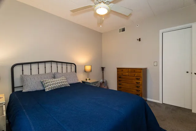 a bedroom with bed and wooden floor