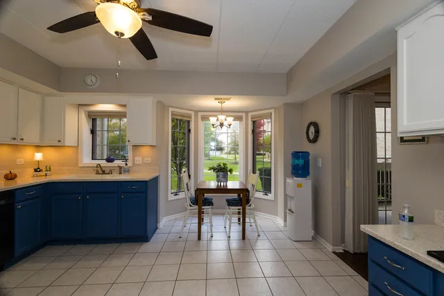 a large kitchen with a large window and chandelier
