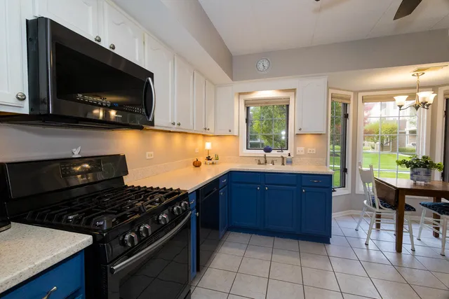 a kitchen with a stove a sink and a microwave