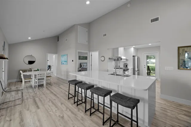 a dining room with furniture and wooden floor