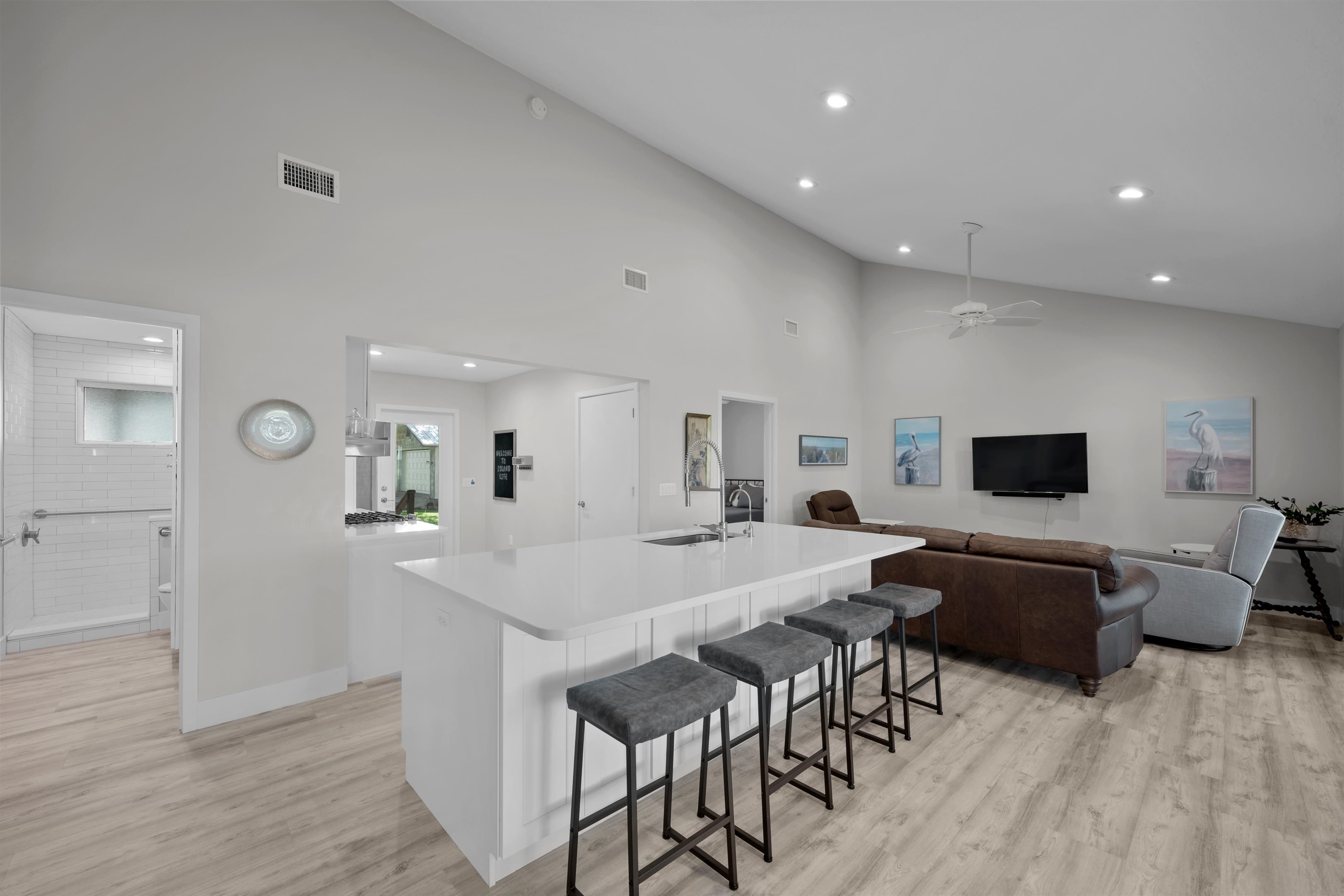 5425 Windantide Road St. Augustine, FL 32080 - Photo 12 of 33 a living room with furniture a flat screen tv and a wooden floor