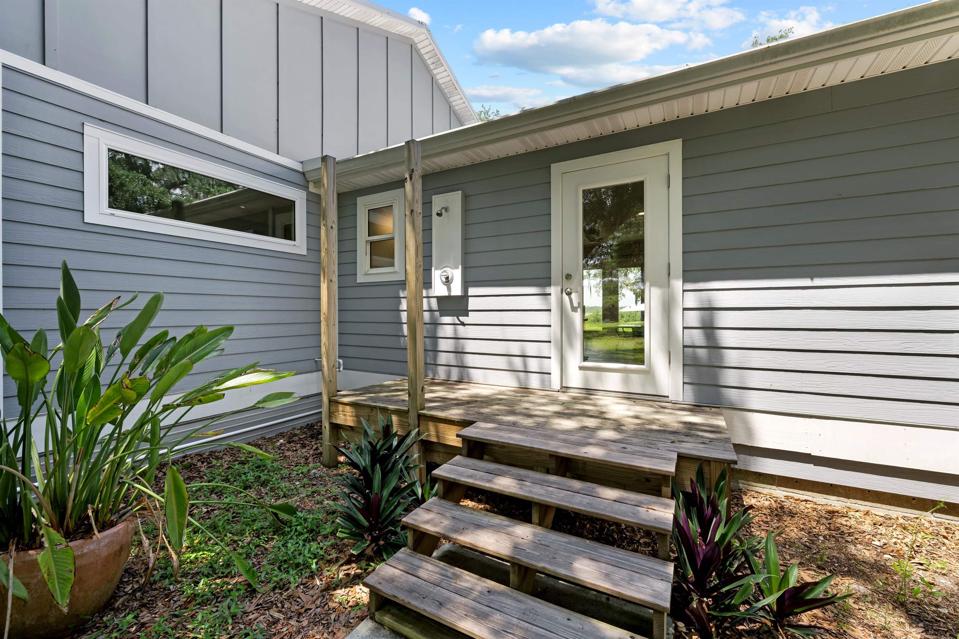 5425 Windantide Road St. Augustine, FL 32080 - Photo 15 of 33 a view of a house with a small deck and a backyard