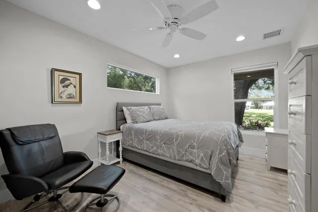 a bedroom with a bed and a chair