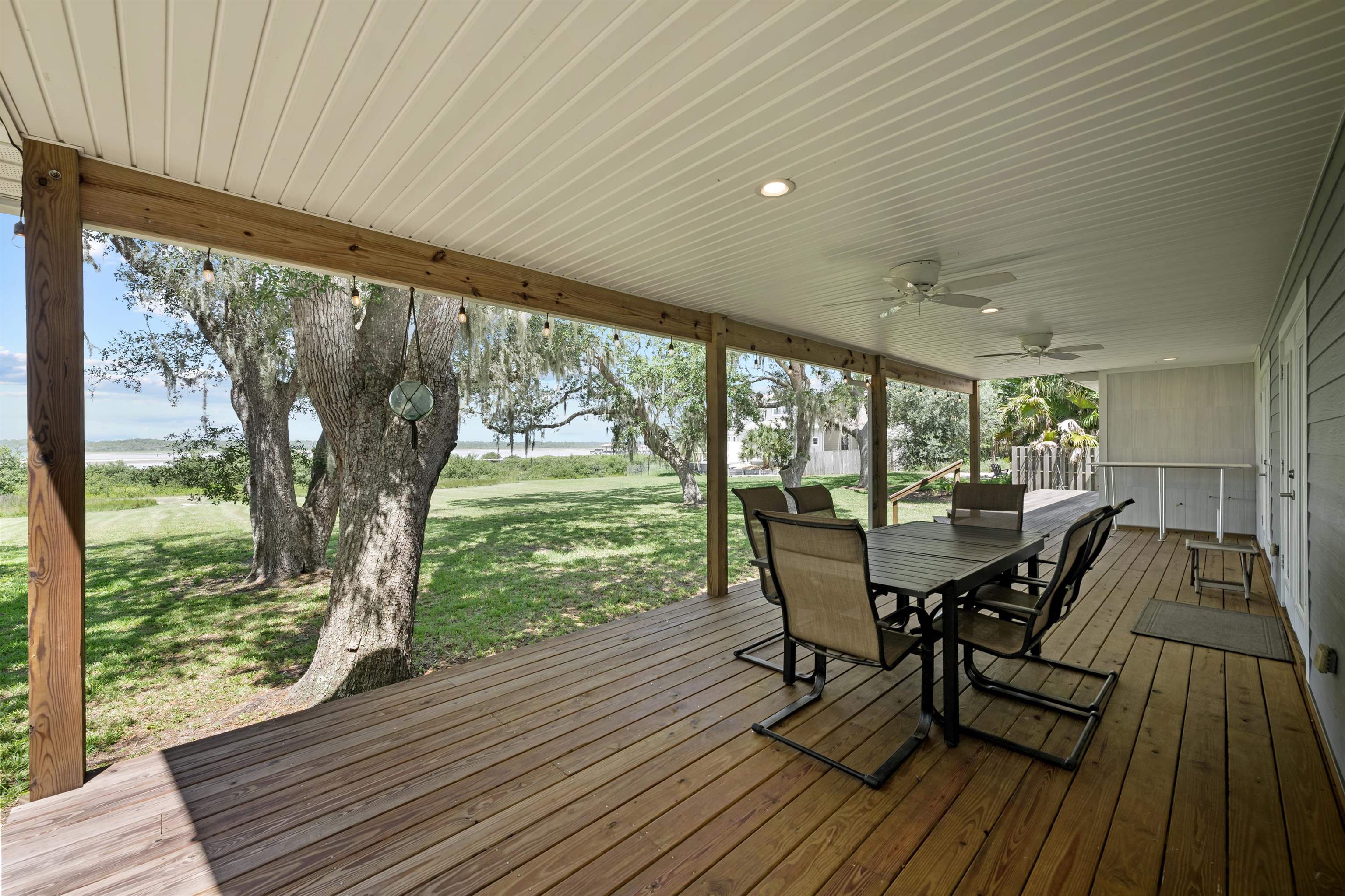 5425 Windantide Road St. Augustine, FL 32080 - Photo 6 of 33 a view of a chairs and table in patio with wooden floor