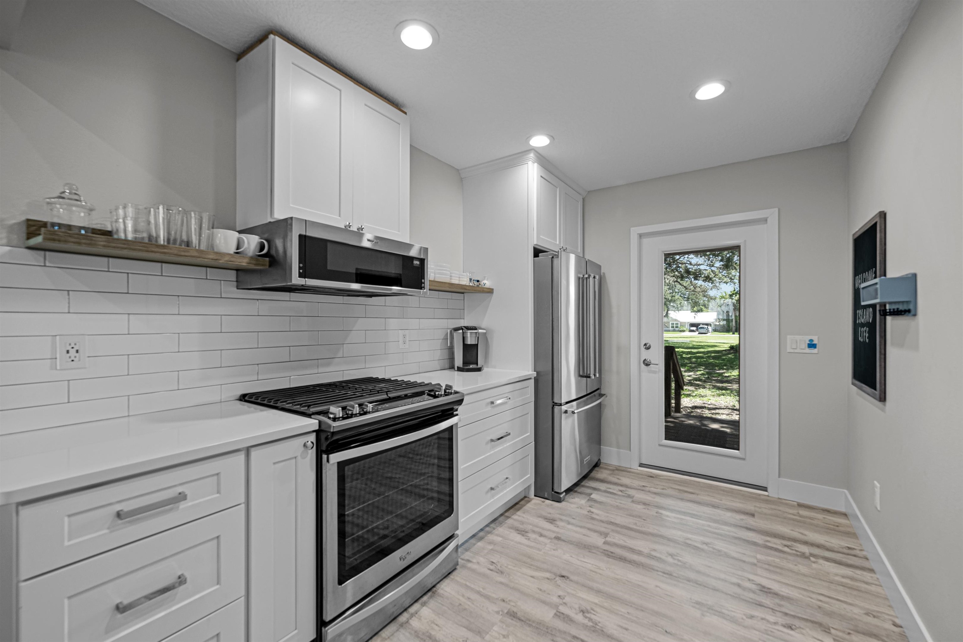 5425 Windantide Road St. Augustine, FL 32080 - Photo 10 of 33 a kitchen with granite countertop a stove a refrigerator and a cabinets