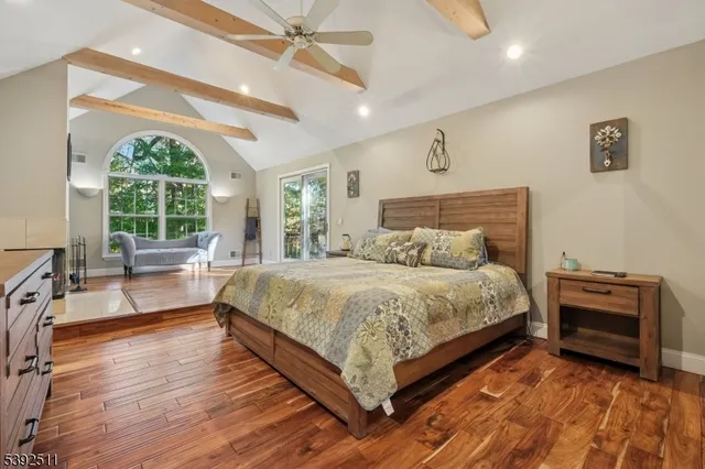 a spacious bedroom with a bed and a large window