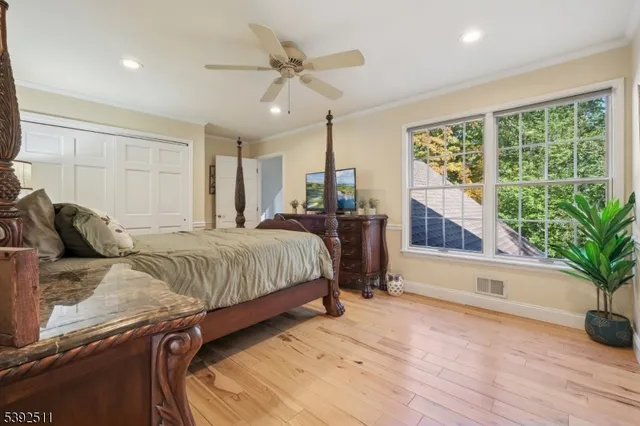 a bedroom with a large bed and a potted plant