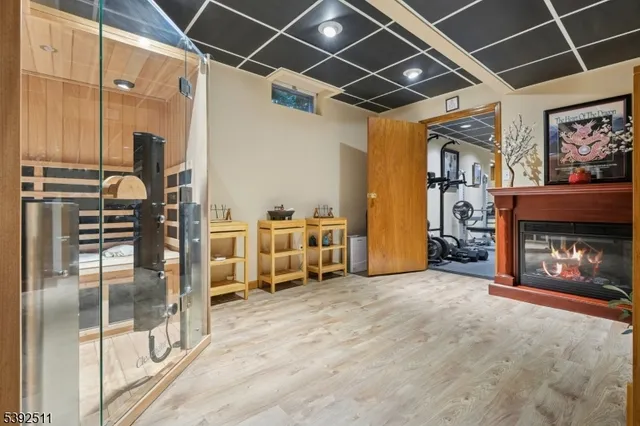 a view of a livingroom with furniture and a refrigerator