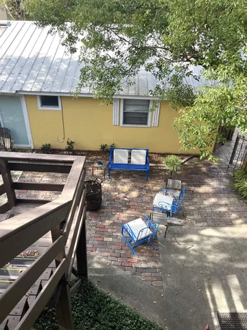 a view of a patio with chairs next to a yard