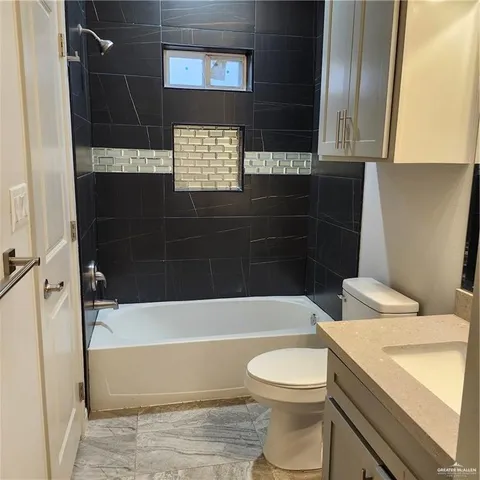 a bathroom with a toilet a sink and bathtub