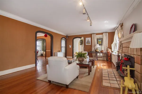 a living room with fireplace furniture and a large window