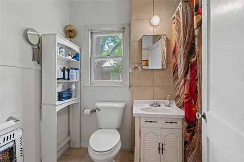 a white toilet sitting next to a bathroom sink