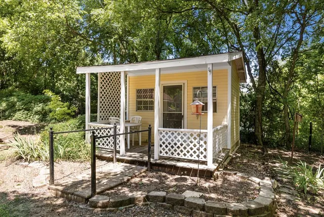 a view of a house with a large window and yard