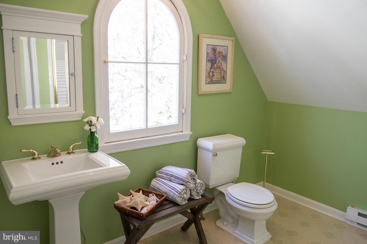 119 Hawthorn Road Baltimore, MD 21210 - Photo 26 of 30 a bathroom with a toilet sink and mirror