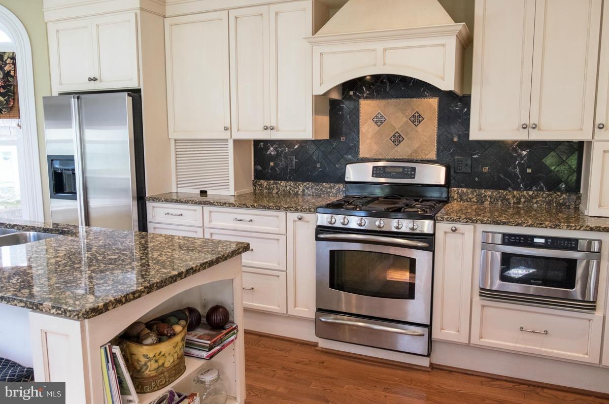 119 Hawthorn Road Baltimore, MD 21210 - Photo 5 of 30 a kitchen with granite countertop a sink stove and cabinets