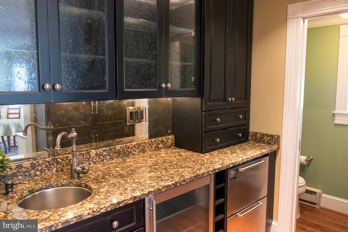 119 Hawthorn Road Baltimore, MD 21210 - Photo 8 of 30 a bathroom with a granite countertop sink and a mirror