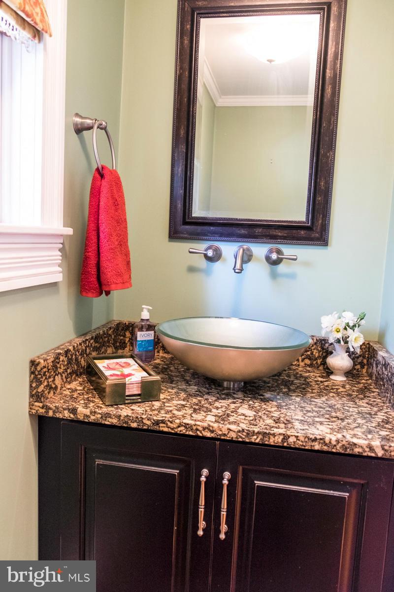 119 Hawthorn Road Baltimore, MD 21210 - Photo 9 of 30 a bathroom with a granite countertop sink and a mirror