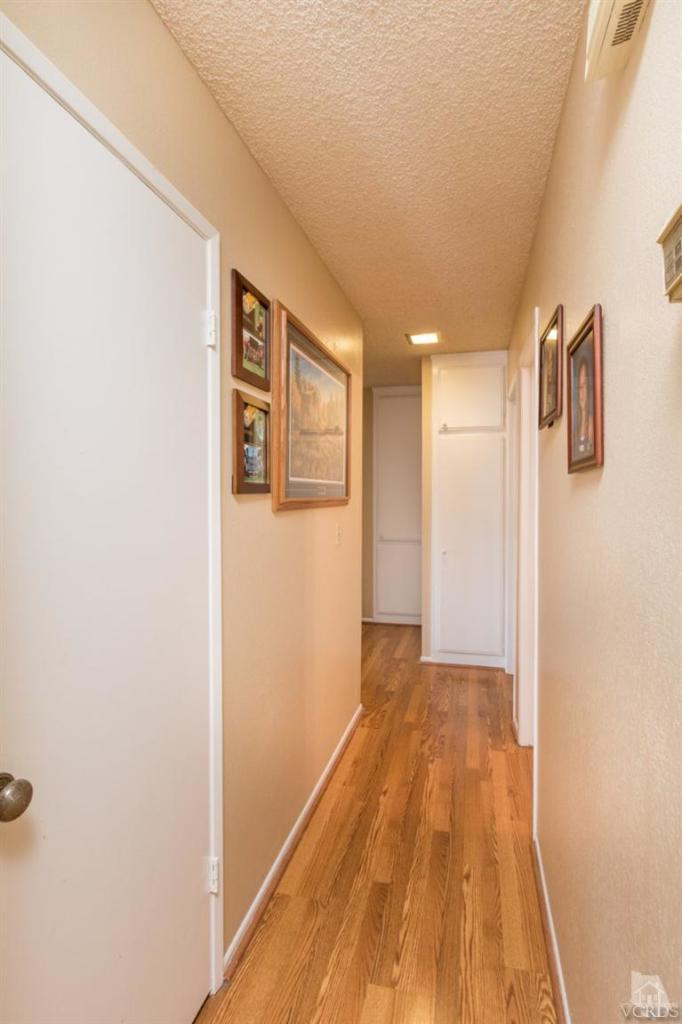 1888 Fitzgerald Road Simi Valley, CA 93065 - Photo 16 of 28 a view of a hallway with wooden floor