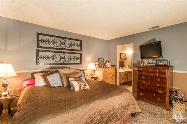 1888 Fitzgerald Road Simi Valley, CA 93065 - Photo 18 of 28 a bedroom with a bed and furniture