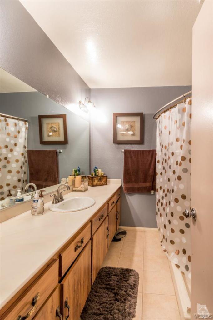 1888 Fitzgerald Road Simi Valley, CA 93065 - Photo 19 of 28 a bathroom with a double vanity sink mirror and shower