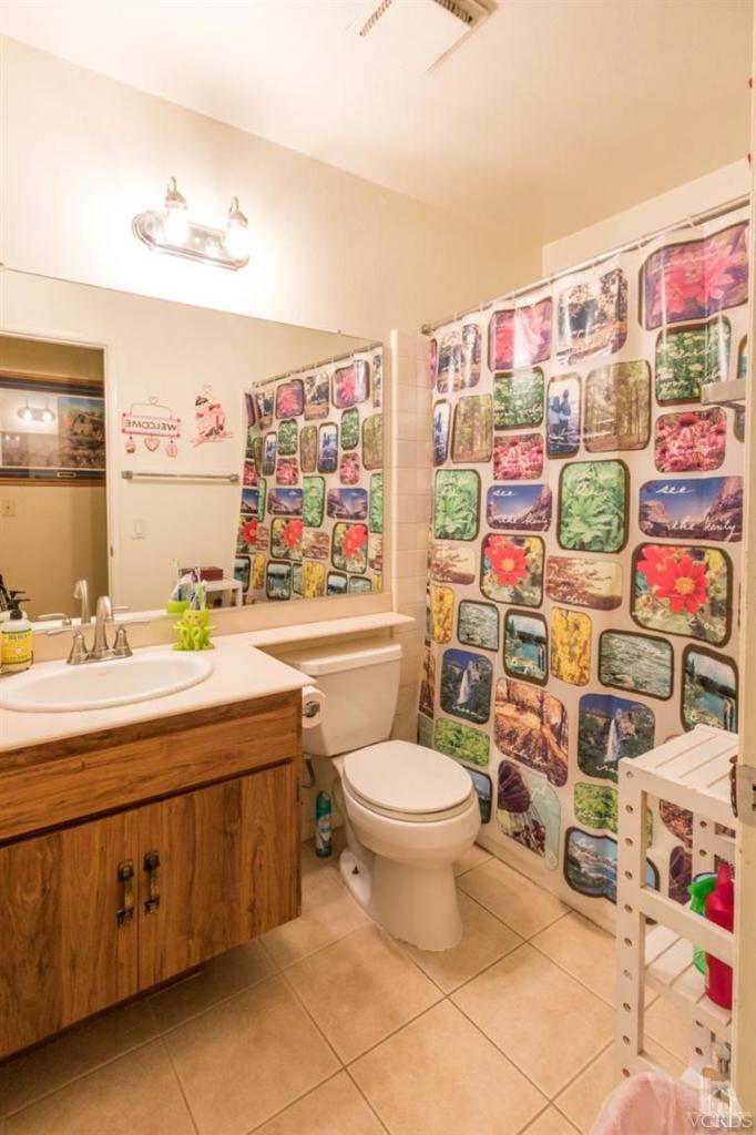 1888 Fitzgerald Road Simi Valley, CA 93065 - Photo 21 of 28 a bathroom with a sink mirror vanity and toilet