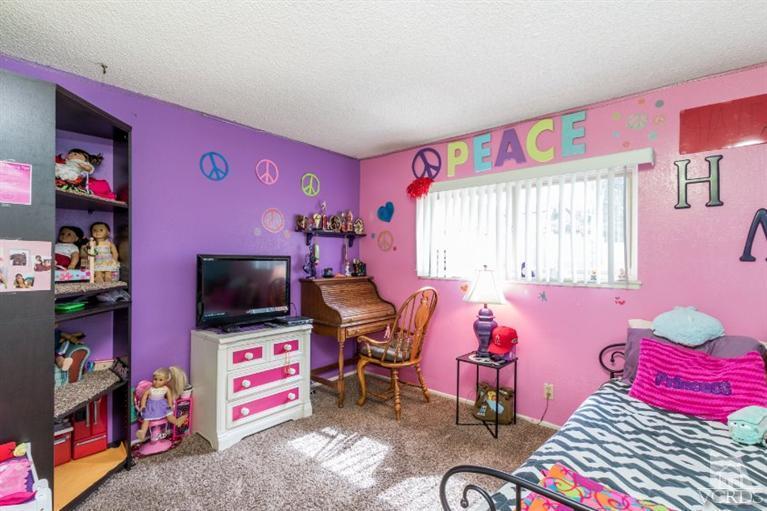 1888 Fitzgerald Road Simi Valley, CA 93065 - Photo 22 of 28 a living room with furniture and a flat screen tv