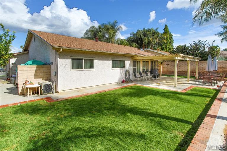 1888 Fitzgerald Road Simi Valley, CA 93065 - Photo 23 of 28 a view of a house with a backyard and a patio