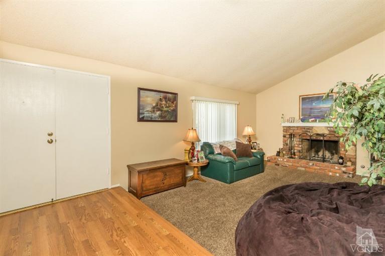 1888 Fitzgerald Road Simi Valley, CA 93065 - Photo 4 of 28 a bedroom with furniture and a fireplace