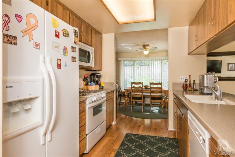 1888 Fitzgerald Road Simi Valley, CA 93065 - Photo 7 of 28 a kitchen with stainless steel appliances a stove a sink and a refrigerator