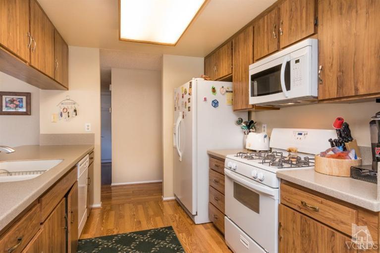 1888 Fitzgerald Road Simi Valley, CA 93065 - Photo 8 of 28 a kitchen with stainless steel appliances granite countertop a refrigerator and a stove