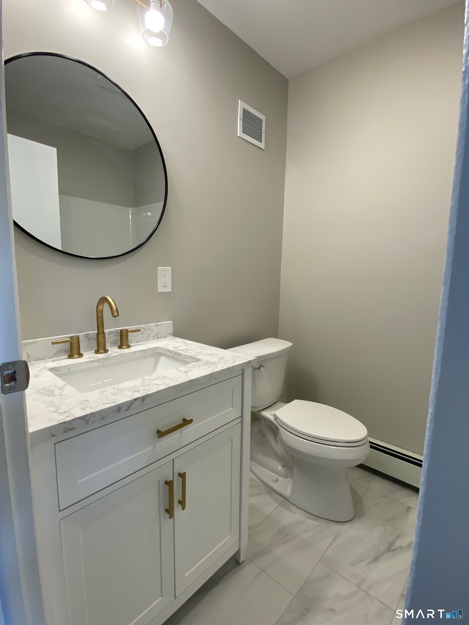 34 Center Street, Unit 2 Bristol, CT 06010 - Photo 12 of 13 a bathroom with a granite countertop toilet sink mirror and vanity