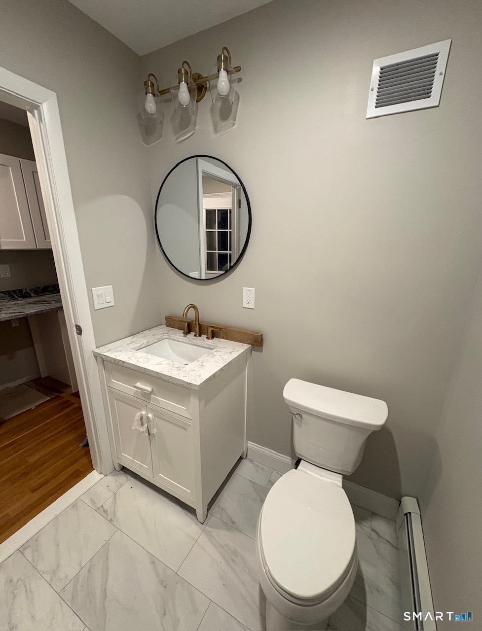 34 Center Street, Unit 2 Bristol, CT 06010 - Photo 5 of 13 a bathroom with a toilet sink and mirror