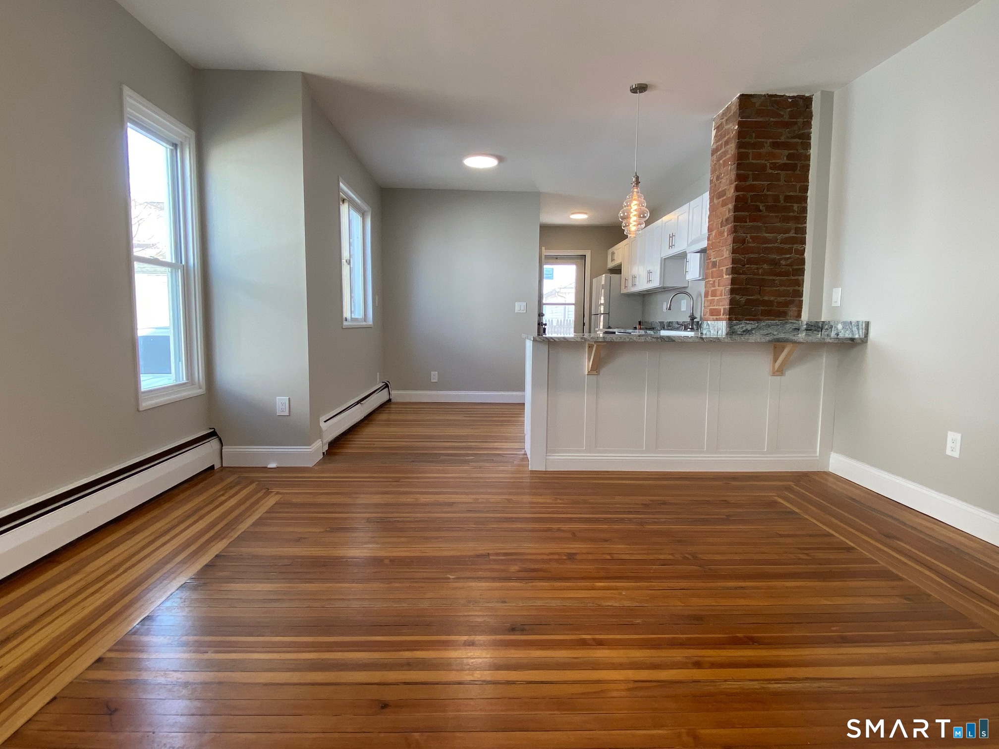 34 Center Street, Unit 2 Bristol, CT 06010 - Photo 6 of 13 a view of a livingroom with wooden floor and window