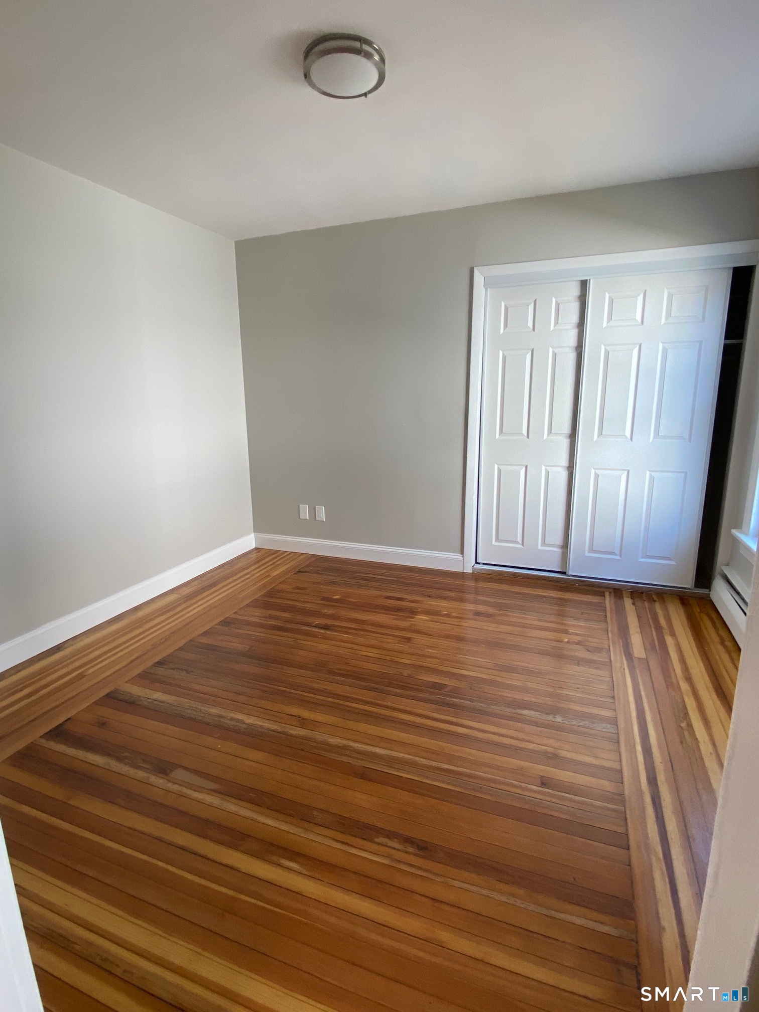34 Center Street, Unit 2 Bristol, CT 06010 - Photo 8 of 13 a view of an empty room with wooden floor