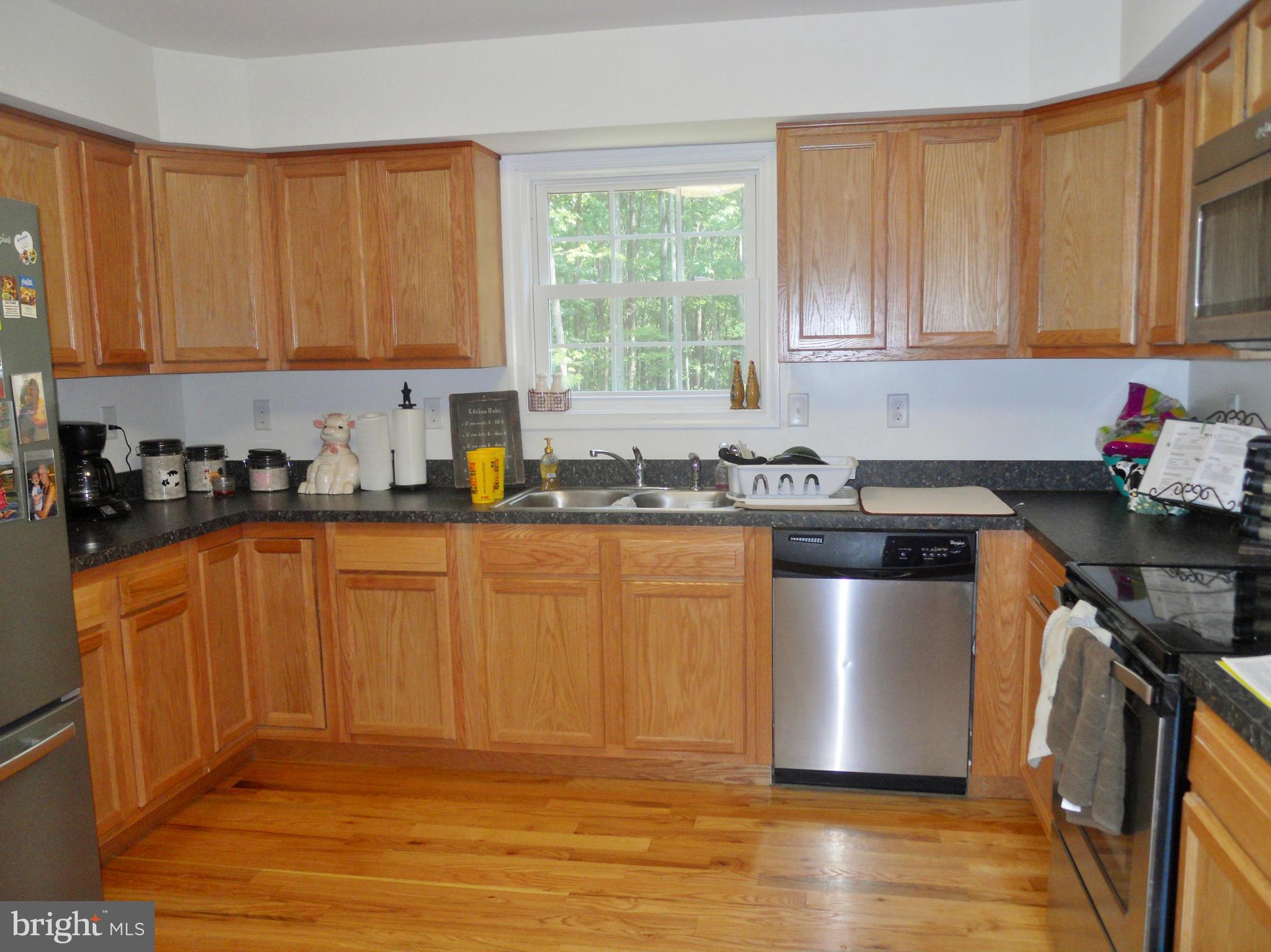 244 Fairview Church Road Gore, VA 22637 - Photo 12 of 30 a kitchen with stainless steel appliances granite countertop a sink a stove a refrigerator cabinets and a window